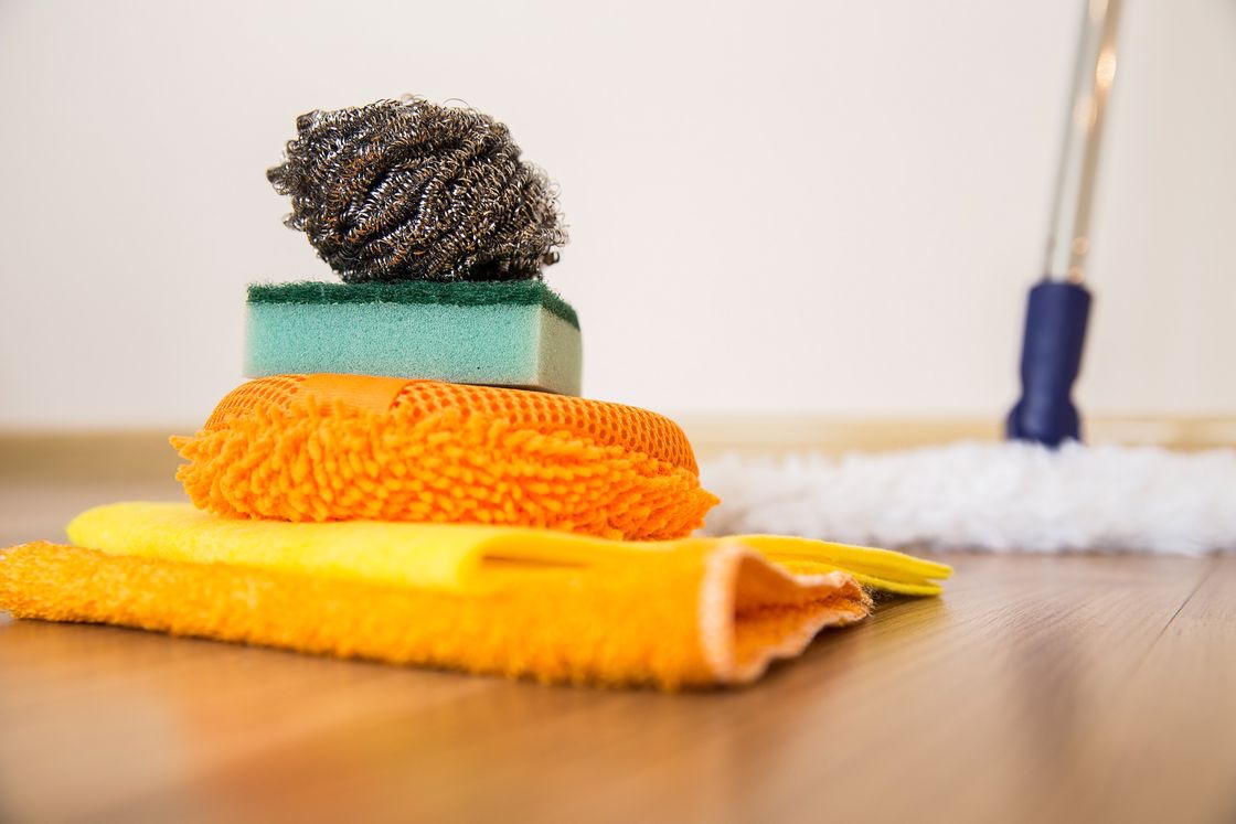 Cleaning rugs and scrub pads folded neatly on the floor