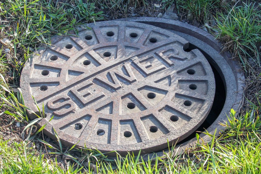 Sewer cover plate that is slightly opened